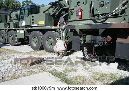 U. S. Marine works on a Kalmar Rough Terrain vehicle. View Large Photo Image Picture - U. S. Marine works on a Kalmar Rough Terrain vehicle.. Fotosearch