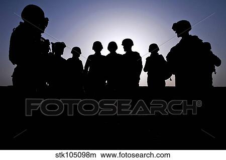 Picture - U. S. Marines and civilian contractors gather around for a briefing.. Fotosearch