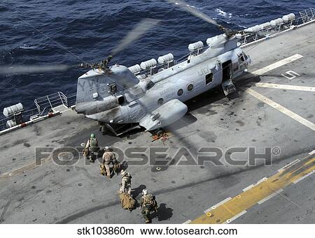 U. S. Marines board a CH-46 Sea Knight helicopter on the flight deck of USS Peleliu. View Large Photo Image Picture - U. S. Marines board a CH-46 Sea Knight helicopter on the flight deck of USS Peleliu.. Fotosearch