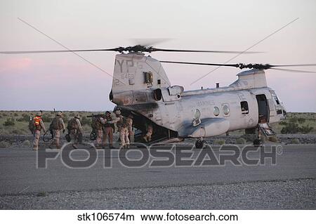 U. S. Marines board a CH-46 Sea Knight helicopter. View Large Photo Image Picture - U. S. Marines board a CH-46 Sea Knight helicopter.. Fotosearch