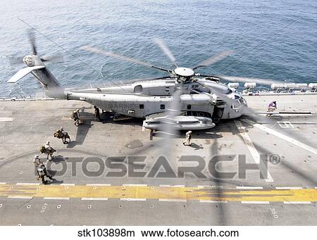 U. S. Marines board an MH-53E Sea Dragon helicopter aboard the USS Peleliu. View Large Photo Image Picture - U. S. Marines board an MH-53E Sea Dragon helicopter aboard the USS Peleliu.. Fotosearch