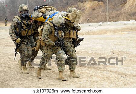 U. S. Marines carry a fellow Marine on a stretcher. View Large Photo Image Picture - U. S. Marines carry a fellow Marine on a stretcher.. Fotosearch