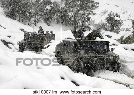 Picture - U. S. Marines conducting a mounted patrol in the snowy weather of the Khowst-Gardez Pass in Afghanistan.. Fotosearch