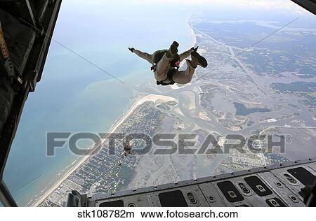 U. S. Marines exit the ramp of a C-130 aircraft over North Carolina. View Large Photo Image Picture - U. S. Marines exit the ramp of a C-130 aircraft over North Carolina.. Fotosearch