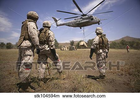 U. S. Marines observe CH-53E Super Stallion lift a 12, 000 pound target. View Large Photo Image Picture - U. S. Marines observe CH-53E Super Stallion lift a 12, 000 pound target.. Fotosearch