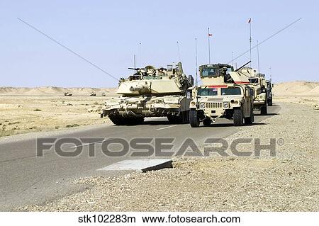 U. S. Marines pass a tank along the road. View Large Photo Image Picture - U. S. Marines pass a tank along the road.. Fotosearch