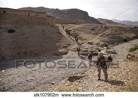 U. S. Marines patrol through a village in Afghanistan. View Large Photo Image Picture - U. S. Marines patrol through a village in Afghanistan.. Fotosearch