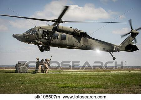 U. S. Marines prepare to attach cargo under a UH-60 Black Hawk. View Large Photo Image Picture - U. S. Marines prepare to attach cargo under a UH-60 Black Hawk.. Fotosearch
