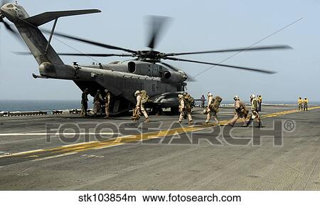 U. S. Marines prepare to board a CH-53E Super Stallion helicopter aboard USS Peleliu. View Large Photo Image Picture - U. S. Marines prepare to board a CH-53E Super Stallion helicopter aboard USS Peleliu.. Fotosearch