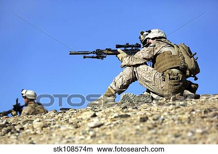 Picture - U. S. Marines provide security during a patrol in Afghanistan.. Fotosearch