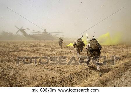 U. S. Marines sprint across a field to load onto a CH-53E Super Stallion. View Large Photo Image Picture - U. S. Marines sprint across a field to load onto a CH-53E Super Stallion.. Fotosearch