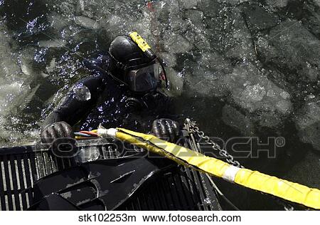 Picture - U. S. Navy Diver gets ready to start his dive off the back of a dive training boat.. Fotosearch