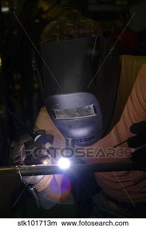 U. S. Navy Hull Maintenance Technician welds a fitting to a pipe. View Large Photo Image Picture - U. S. Navy Hull Maintenance Technician welds a fitting to a pipe.. Fotosearch