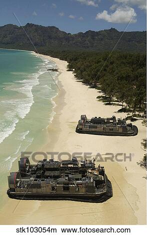 U. S. Navy Landing Craft land on the beach to offload equipment in Oahu, Hawaii. View Large Photo Image Picture - U. S. Navy Landing Craft land on the beach to offload equipment in Oahu, Hawaii.. Fotosearch