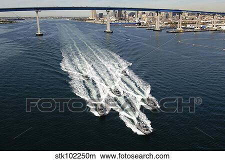 Picture - U. S. Navy patrol boats conduct operations near the Coronado Bay Bridge in San Diego, California.. Fotosearch