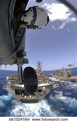 U. S. Navy Petty Officer leans out the door of an SH-60 Seahawk. View Large Photo Image Picture - U. S. Navy Petty Officer leans out the door of an SH-60 Seahawk.. Fotosearch