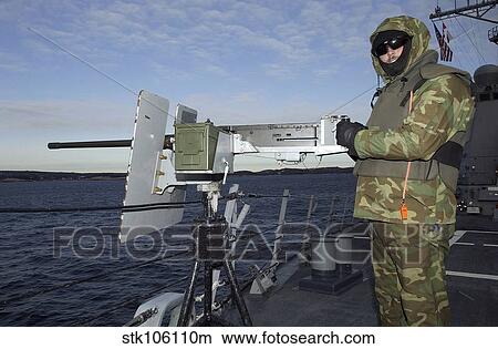 U. S. Navy Petty Officer mans a. 50 caliber M2 machine gun. View Large Photo Image Picture - U. S. Navy Petty Officer mans a. 50 caliber M2 machine gun.. Fotosearch