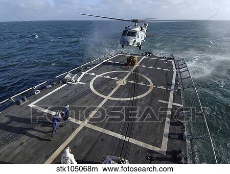 U. S. Navy sailors prepare to attach a pallet of supplies to an SH-60B Seahawk helicopter. View Large Photo Image Picture - U. S. Navy sailors prepare to attach a pallet of supplies to an SH-60B Seahawk helicopter.. Fotosearch