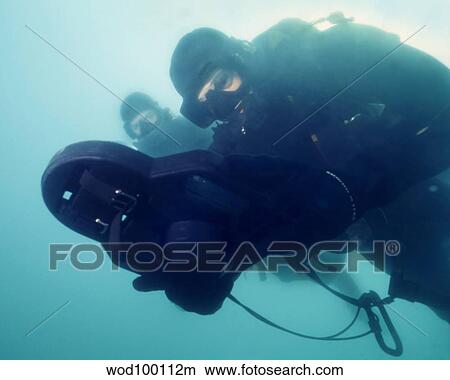 U. S. Navy SEAL combat swimmer pair navigate the waters of Pearl Harbor, Hawaii. View Large Photo Image Picture - U. S. Navy SEAL combat swimmer pair navigate the waters of Pearl Harbor, Hawaii.. Fotosearch