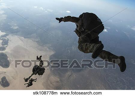 U. S. Pararescuemen and U. S. Marines jump from a HC-130 over Djibouti. View Large Photo Image Picture - U. S. Pararescuemen and U. S. Marines jump from a HC-130 over Djibouti.. Fotosearch