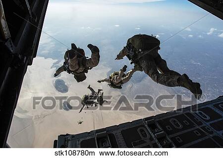U. S. Pararescuemen and U. S. Marines jump from a HC-130 over Djibouti. View Large Photo Image Picture - U. S. Pararescuemen and U. S. Marines jump from a HC-130 over Djibouti.. Fotosearch