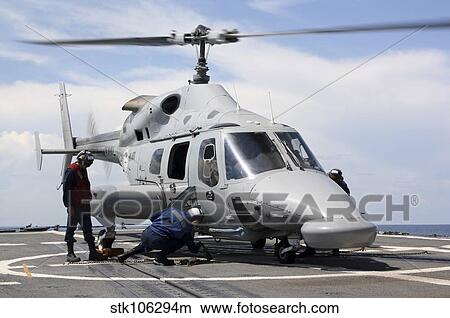 U. S. Sailors chock and chain an Ecuadorian Navy Bell 230 helicopter. View Large Photo Image Picture - U. S. Sailors chock and chain an Ecuadorian Navy Bell 230 helicopter.. Fotosearch