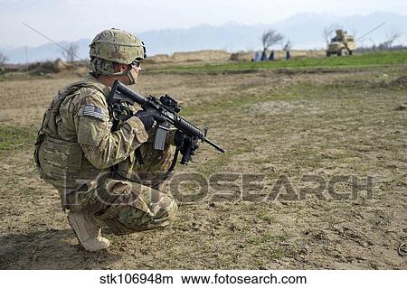 U. S. Soldier patrols a village in Afghanistan. View Large Photo Image Picture - U. S. Soldier patrols a village in Afghanistan.. Fotosearch