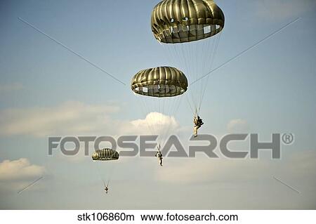 U. S. Soldiers descend through the sky after exiting a C-23 Sherpa. View Large Photo Image Picture - U. S. Soldiers descend through the sky after exiting a C-23 Sherpa.. Fotosearch
