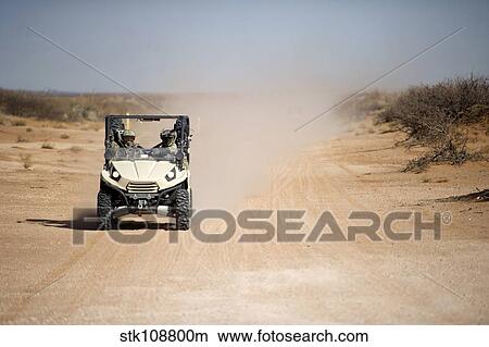 U. S. Soldiers drive a LTATV down a dirt road. View Large Photo Image Picture - U. S. Soldiers drive a LTATV down a dirt road.. Fotosearch