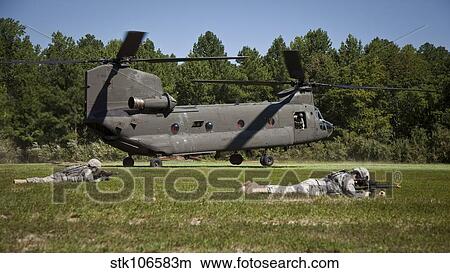 Picture - U. S. Soldiers provide security for a CH-47 Chinook helicopter.. Fotosearch