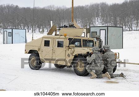 U. S. soldiers take cover behind a humvee during Combat Support Training Exercises. View Large Photo Image Picture - U. S. soldiers take cover behind a humvee during Combat Support Training Exercises.. Fotosearch