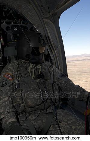 Picture - UH-60 Black Hawk crew chief takes in the view over New Mexico.. Fotosearch