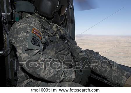 UH-60 Black Hawk crew chief takes in the view over New Mexico. View Large Photo Image Picture - UH-60 Black Hawk crew chief takes in the view over New Mexico.. Fotosearch