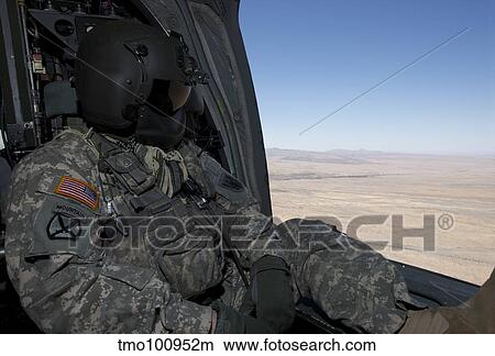 UH-60 Black Hawk crew chief takes in the view over New Mexico. View Large Photo Image Picture - UH-60 Black Hawk crew chief takes in the view over New Mexico.. Fotosearch