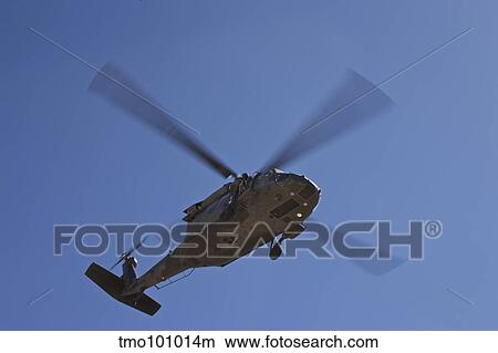 UH-60 Black Hawk helicopter flies overhead in New Mexico. View Large Photo Image Picture - UH-60 Black Hawk helicopter flies overhead in New Mexico.. Fotosearch