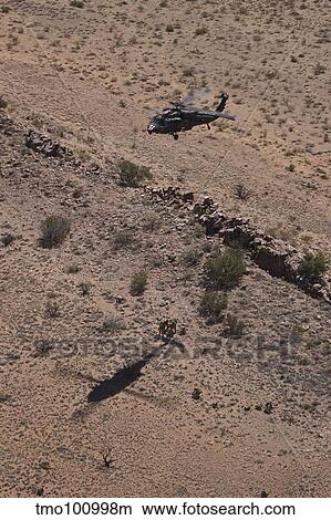 UH-60 Black Hawk hovers above U. S. Marines for extraction. View Large Photo Image Picture - UH-60 Black Hawk hovers above U. S. Marines for extraction.. Fotosearch