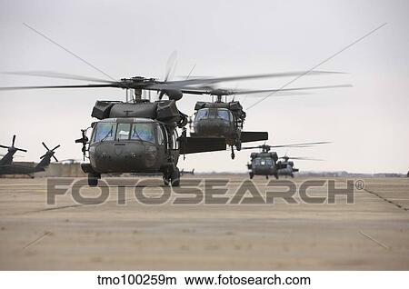 Picture - UH-60 Black Hawks taxis out for a mission over northern Iraq.. Fotosearch