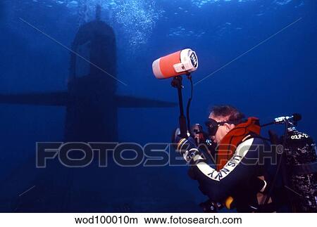 Underwater photographer takes photos of a U. S. submarine. View Large Photo Image Picture - Underwater photographer takes photos of a U. S. submarine.. Fotosearch