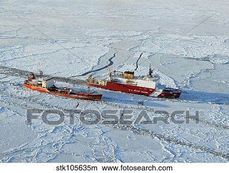 USCG Healy breaks ice around a Russian-flagged tanker south of Nome, Alaska. View Large Photo Image Picture - USCG Healy breaks ice around a Russian-flagged tanker south of Nome, Alaska.. Fotosearch