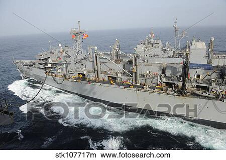 Picture - USNS Rainier transits alongside USS Nimitz during a replenishment at sea.. Fotosearch