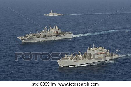 Picture - USNS Robert E. Peary conducts a vertical replenishment with USS Bataan.. Fotosearch