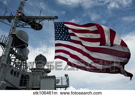 USS Cowpens flies a large American flag during a live fire weapons shoot. View Large Photo Image Picture - USS Cowpens flies a large American flag during a live fire weapons shoot.. Fotosearch