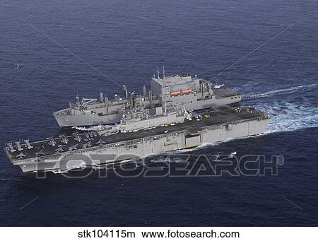 USS Kearsarge pulls alongside USNS Lewis and Clark for a replenishment at sea. View Large Photo Image Picture - USS Kearsarge pulls alongside USNS Lewis and Clark for a replenishment at sea.. Fotosearch