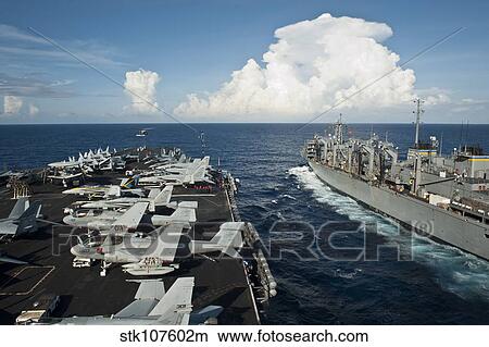 Picture - USS Nimitz and USNS Rainer transit alongside each other.. Fotosearch