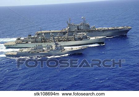 Picture - USS Peleliu and USS Spruance conduct a replenishment at sea with USNS Rainier.. Fotosearch