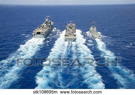 Picture - USS Peleliu and USS Spruance conduct a replenishment at sea with USNS Rainier.. Fotosearch