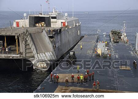 Vehicles are transferred aboard the high speed vessel Swift. View Large Photo Image Picture - Vehicles are transferred aboard the high speed vessel Swift.. Fotosearch