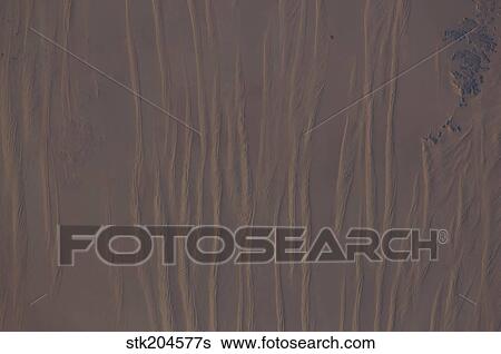 Stock Photograph - View from space of linear dunes in the Great Sand Sea in southwest Egypt.. Fotosearch