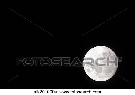 View of a full Moon, also shows Mars, which appears as a small dot. View Large Photo Image Stock Photograph - View of a full Moon, also shows Mars, which appears as a small dot.. Fotosearch