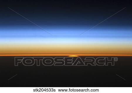 View of the sun peeking over the limb of the Earth. View Large Photo Image Stock Photograph - View of the sun peeking over the limb of the Earth.. Fotosearch